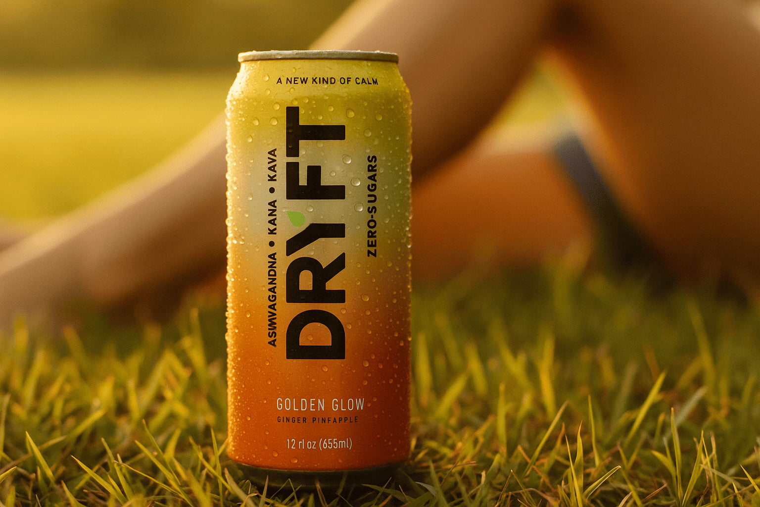 DrYft Golden Glow can on grass at sunset, ginger and pineapple relaxation drink